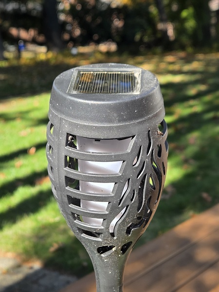 Close-up of a solar garden lamp and its small solar panel